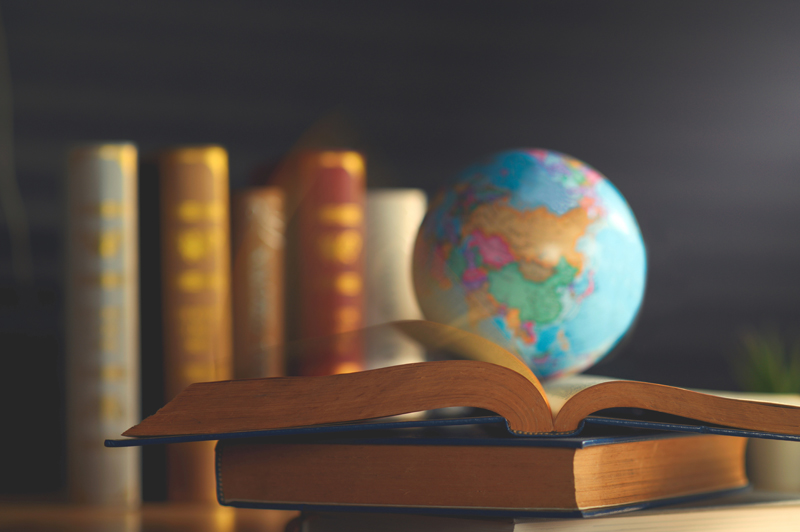 books and and globe on a desk